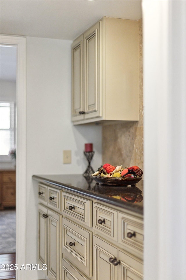 bar featuring cream cabinetry