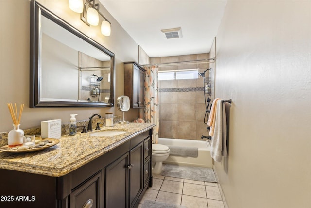 full bathroom with tile patterned floors, vanity, toilet, and tiled shower / bath combo