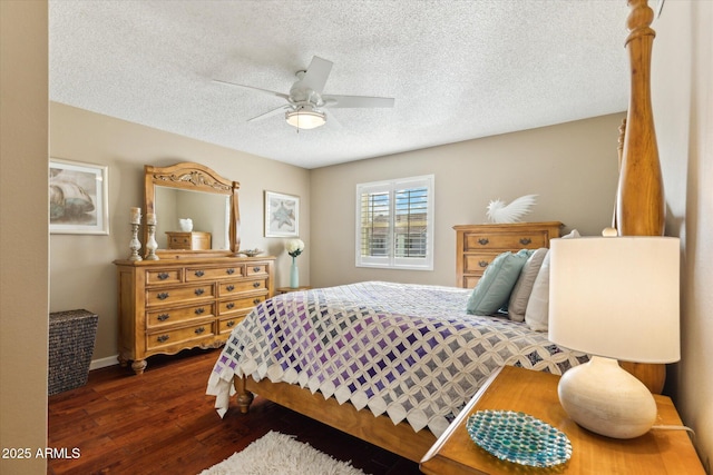 bedroom featuring ceiling fan, dark hardwood / wood-style floors, and a textured ceiling