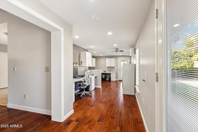 interior space featuring ceiling fan, refrigerator, white cabinets, and dark hardwood / wood-style flooring