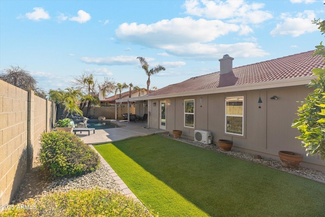 back of house featuring a yard and a patio area