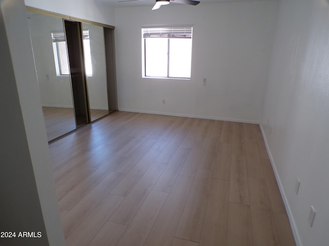 spare room with light hardwood / wood-style floors and ceiling fan