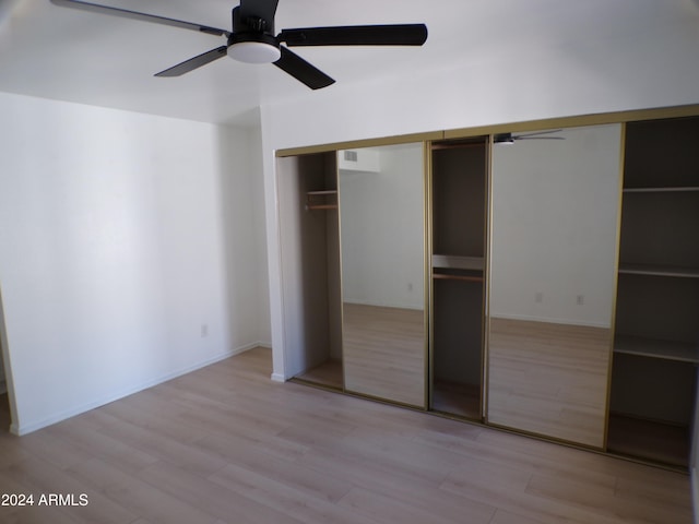 unfurnished bedroom featuring ceiling fan, a closet, and light hardwood / wood-style floors