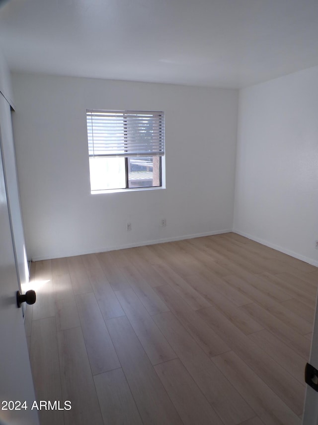 spare room featuring light hardwood / wood-style floors