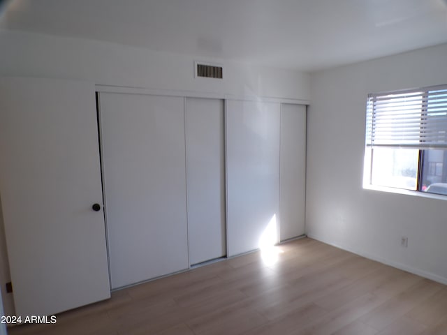 unfurnished bedroom featuring light wood-type flooring