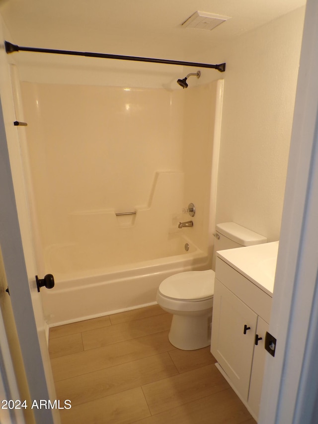 full bathroom featuring vanity, wood-type flooring, tub / shower combination, and toilet