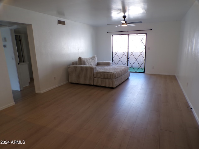 unfurnished living room with ceiling fan and hardwood / wood-style floors