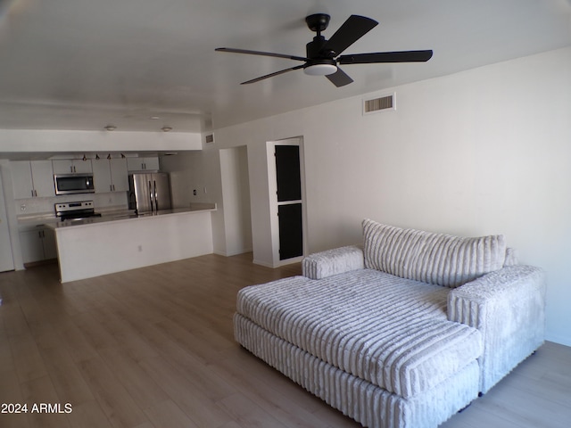 interior space with ceiling fan and light hardwood / wood-style flooring