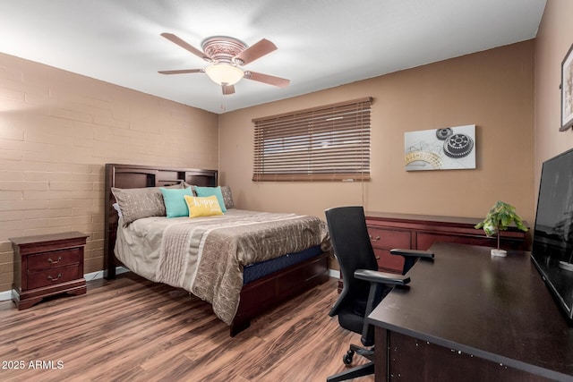 1133 N 84th Pl, Scottsdale, AZ 85257 - bedroom with wood finished floors, a desk, a ceiling fan, and brick wall