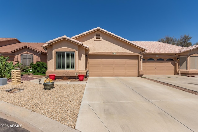 6610 E University Dr Unit 2, Mesa, AZ 85205 - view of front facade with a garage, stucco siding, driveway, and a tile roof