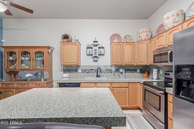 6610 E University Dr Unit 2, Mesa, AZ 85205 - kitchen featuring stainless steel appliances, light countertops, a ceiling fan, and decorative backsplash