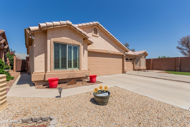 6610 E University Dr Unit 2, Mesa, AZ 85205 - view of front of property with an attached garage, stucco siding, driveway, and a tiled roof
