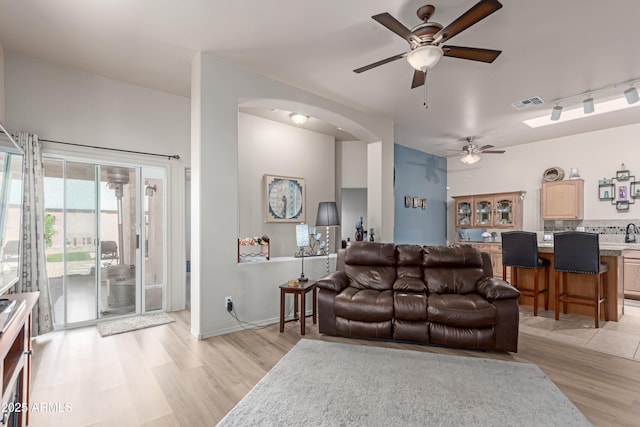 6610 E University Dr Unit 2, Mesa, AZ 85205 - living room featuring ceiling fan, light wood-type flooring, and arched walkways