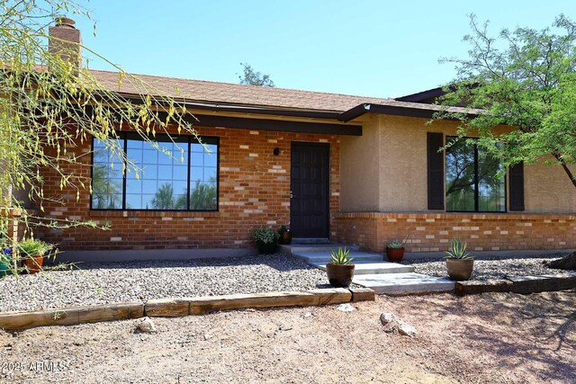 6608 E Ranch Rd, Cave Creek, AZ 85331 - ranch-style house with brick siding and a chimney