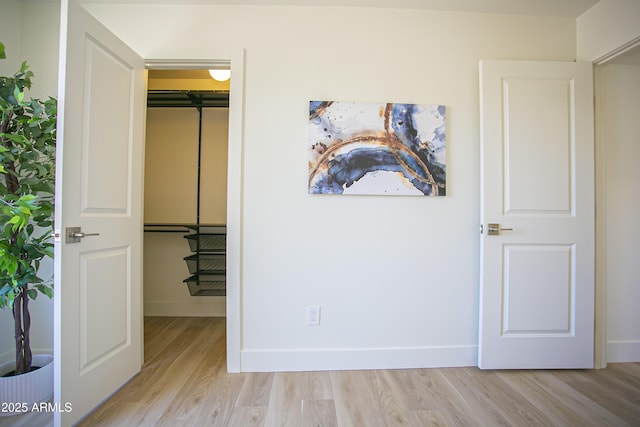6608 E Ranch Rd, Cave Creek, AZ 85331 - unfurnished bedroom with light wood-type flooring and a walk in closet