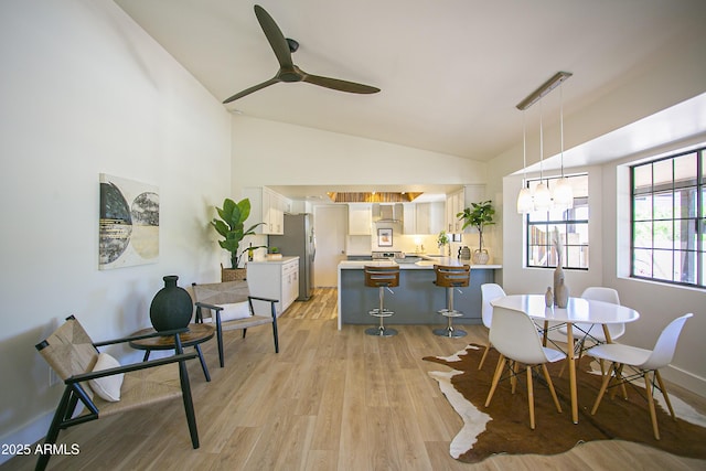 6608 E Ranch Rd, Cave Creek, AZ 85331 - dining space featuring light wood finished floors, ceiling fan, a chandelier, and high vaulted ceiling