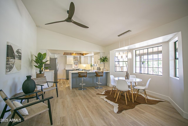6608 E Ranch Rd, Cave Creek, AZ 85331 - dining area featuring a ceiling fan, light wood finished floors, and vaulted ceiling