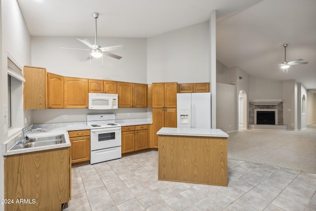 kitchen with white appliances, high vaulted ceiling, sink, ceiling fan, and light colored carpet