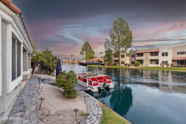 exterior space featuring a boat dock and a water view