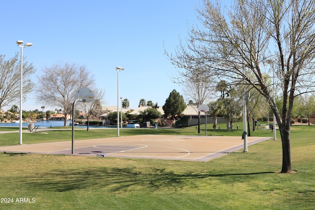 view of sport court with a lawn