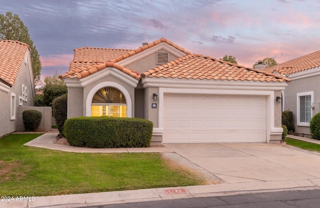 mediterranean / spanish-style house with a garage