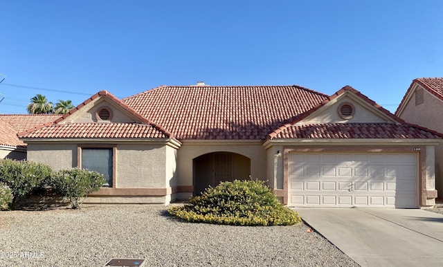 1249 E Commerce Ave, Gilbert, AZ 85234 - mediterranean / spanish house featuring stucco siding, driveway, an attached garage, and a tile roof