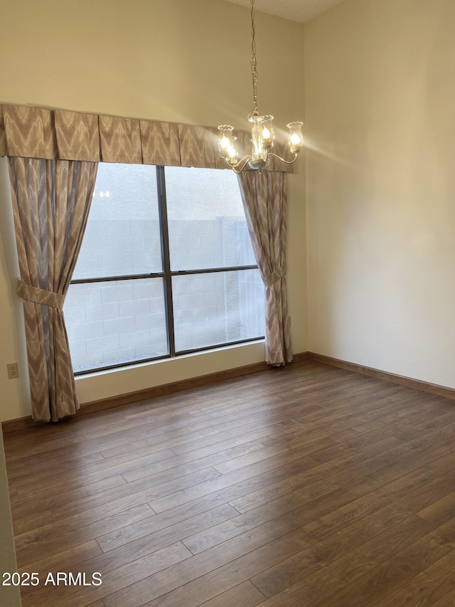 1249 E Commerce Ave, Gilbert, AZ 85234 - unfurnished dining area featuring a chandelier and wood finished floors