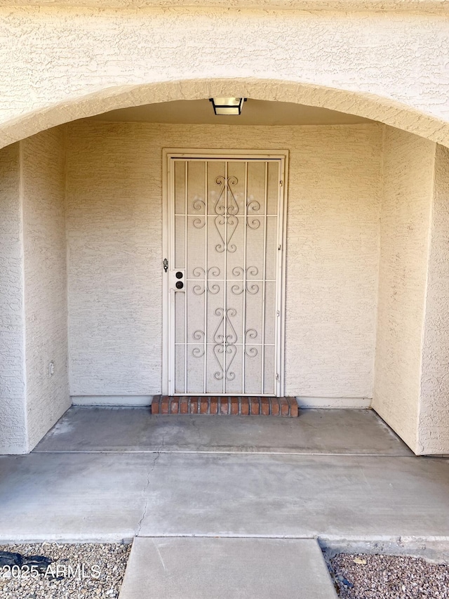1249 E Commerce Ave, Gilbert, AZ 85234 - doorway to property featuring stucco siding