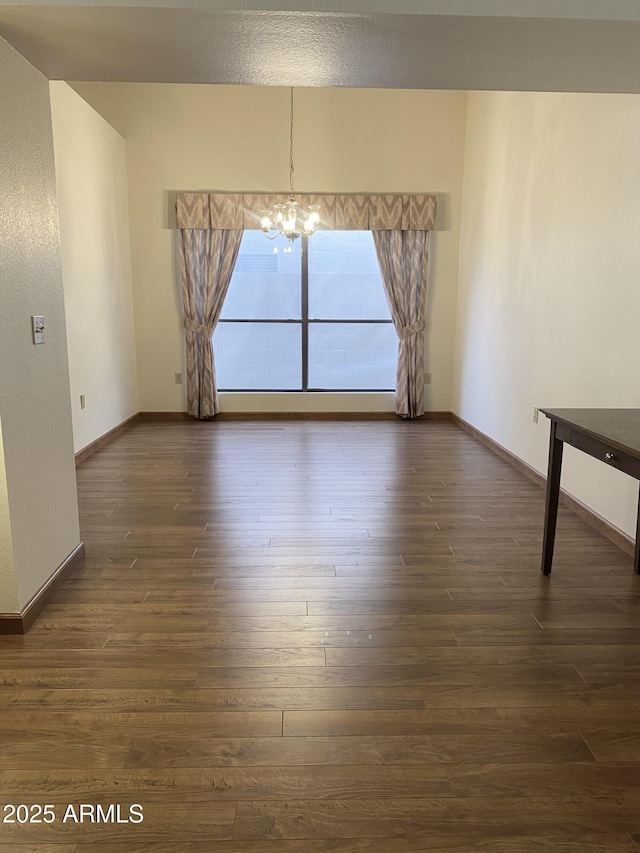 1249 E Commerce Ave, Gilbert, AZ 85234 - unfurnished room featuring a chandelier and dark wood-type flooring
