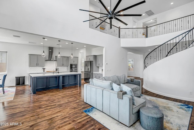 32083 N 126th Ave, Peoria, AZ 85383 - living area with dark wood finished floors, stairway, a towering ceiling, a chandelier, and baseboards