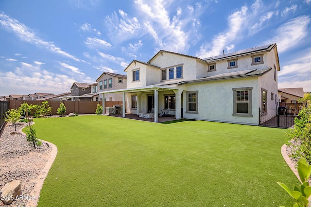 32083 N 126th Ave, Peoria, AZ 85383 - rear view of house with stucco siding, roof mounted solar panels, and a patio