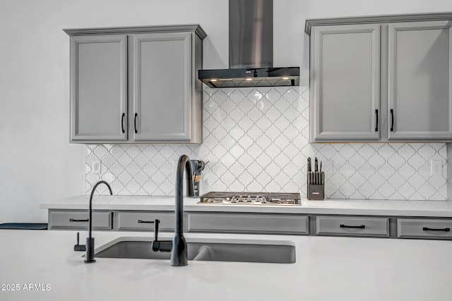 32083 N 126th Ave, Peoria, AZ 85383 - kitchen with wall chimney range hood, gray cabinets, a sink, stainless steel gas stovetop, and light countertops