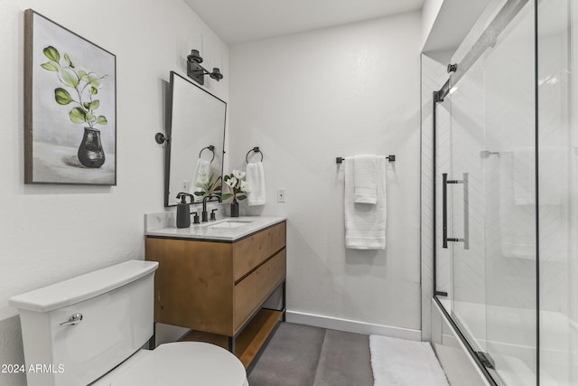 bathroom with vanity, toilet, and an enclosed shower