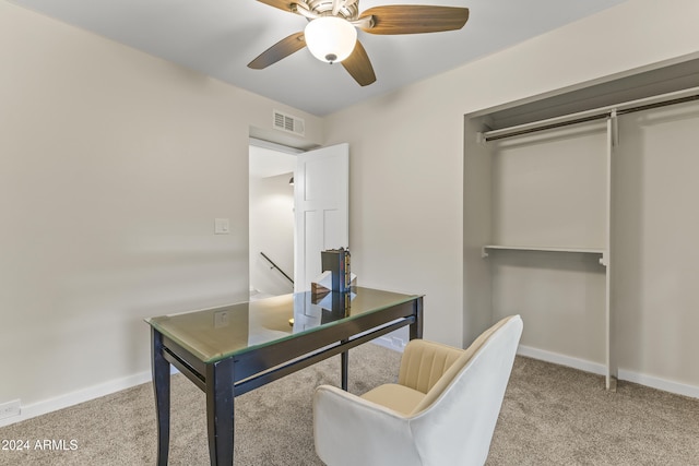 carpeted office space with ceiling fan