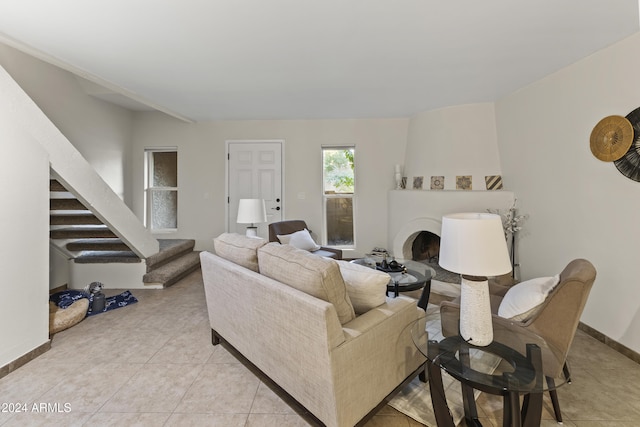 living room featuring light tile patterned flooring and a fireplace