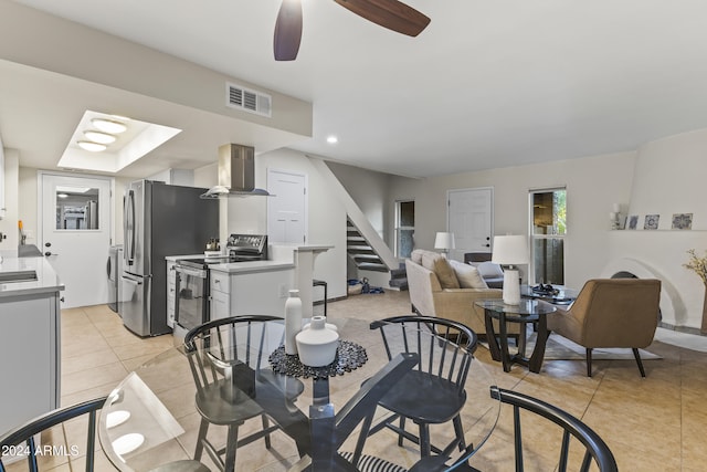 tiled dining room featuring ceiling fan