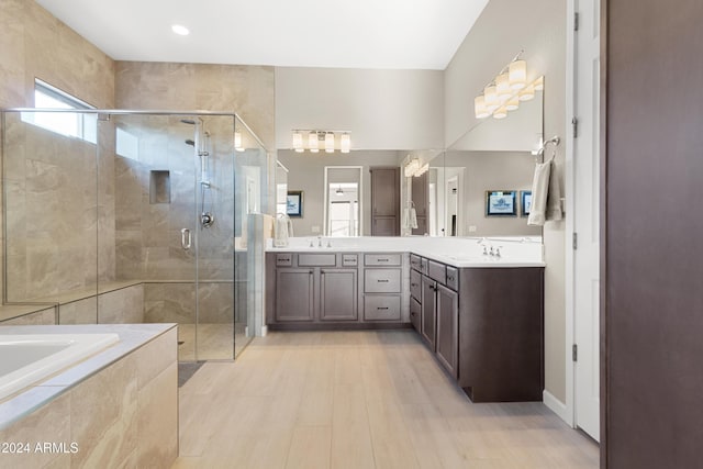 bathroom featuring vanity and shower with separate bathtub