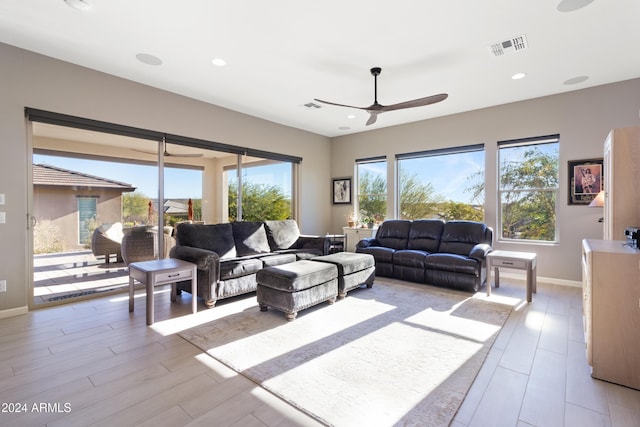 living room with baseboards, recessed lighting, visible vents, and a ceiling fan