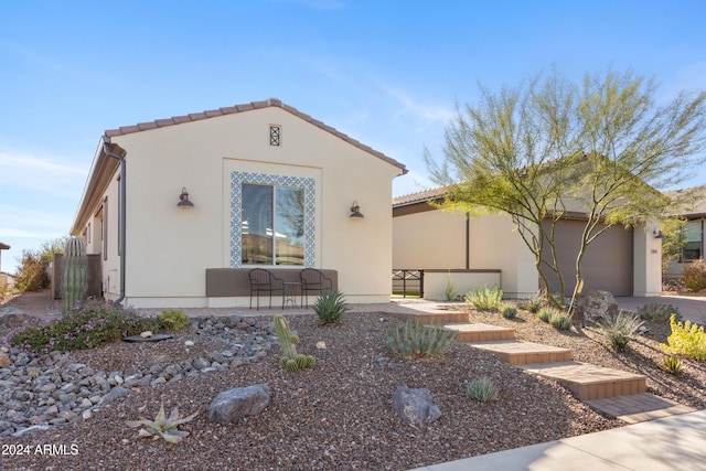 mediterranean / spanish-style home with a garage