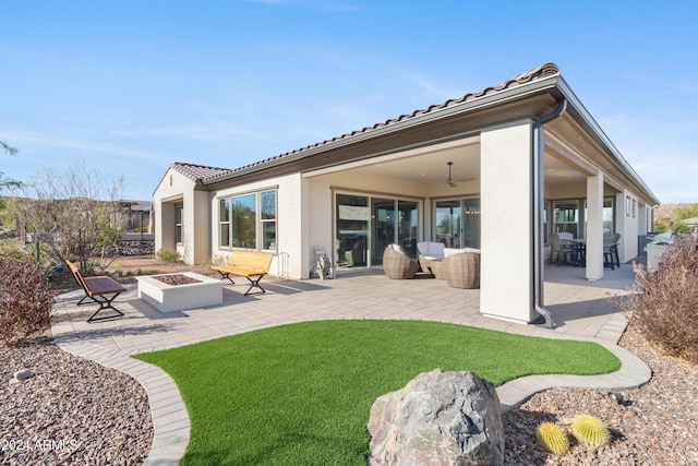 back of house featuring a patio, a fire pit, and ceiling fan