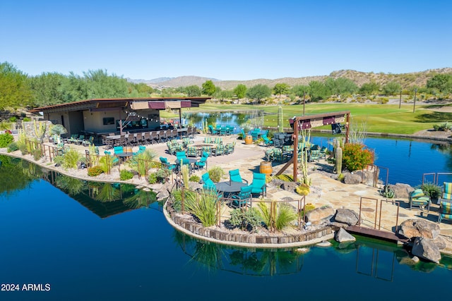 birds eye view of property with a water and mountain view