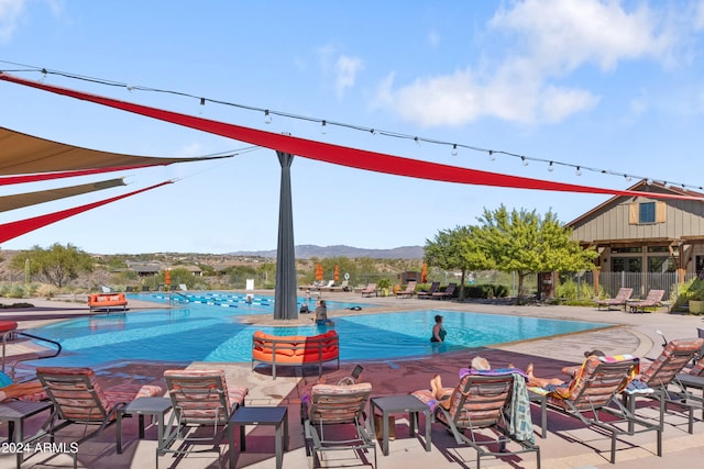 view of swimming pool featuring a mountain view and a patio