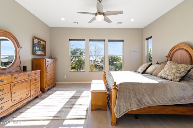 bedroom with ceiling fan and light wood-type flooring