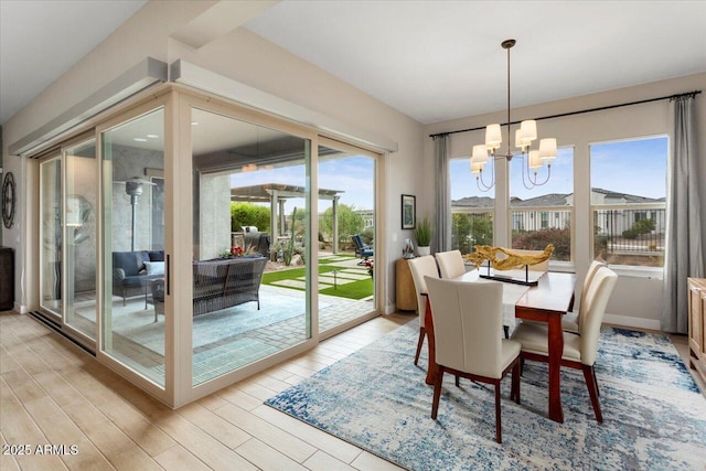 dining space with a chandelier, light hardwood / wood-style flooring, and plenty of natural light