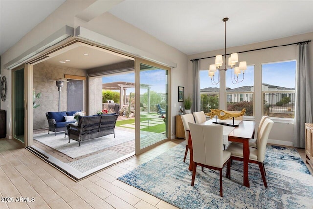 dining space with a chandelier and light hardwood / wood-style flooring