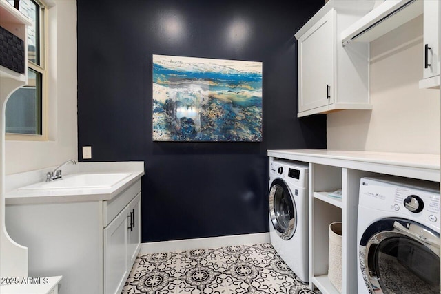 washroom featuring washer and dryer, light tile patterned flooring, sink, and cabinets