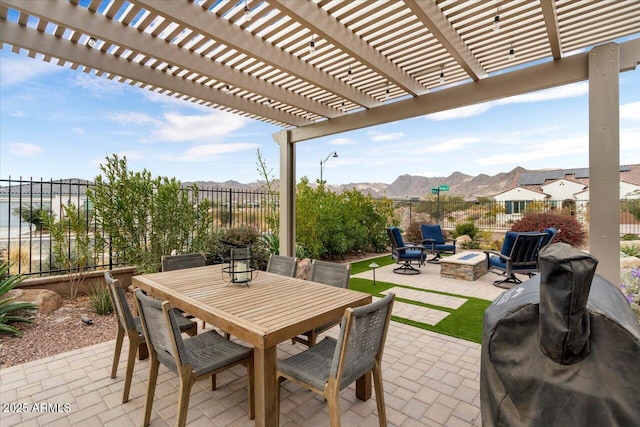 view of patio featuring an outdoor fire pit, a pergola, and a mountain view