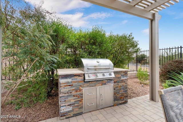 view of patio / terrace featuring a pergola, an outdoor kitchen, and area for grilling