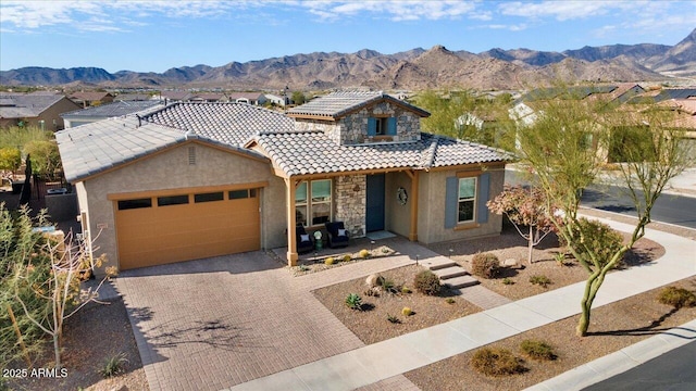 view of front of house with a garage and a mountain view