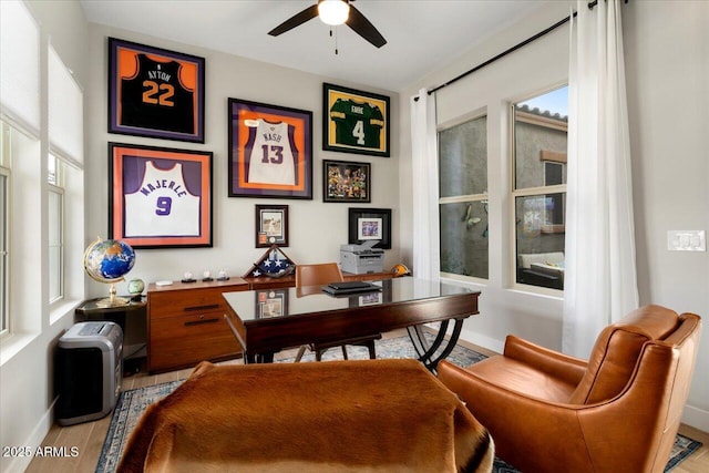 office space featuring light wood-type flooring and ceiling fan